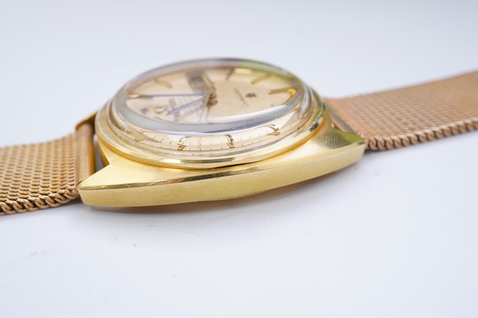 A gentleman's late 1960's 18ct gold Omega Constellation Automatic Chronometer Officially Certified wrist watch, on an associated 9ct gold mesh link bracelet